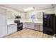 Modern kitchen with gray cabinets, white countertops, and black appliances at 6354 River Run Dr, Indianapolis, IN 46221