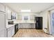 Modern kitchen with gray cabinets, white countertops, and black appliances at 6354 River Run Dr, Indianapolis, IN 46221