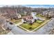 Aerial view of a suburban home with mature trees and view of a pond at 6530 Duck Pond Dr, Fishers, IN 46038
