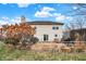 Large backyard featuring a patio, lush greenery, and natural landscaping elements at 6530 Duck Pond Dr, Fishers, IN 46038