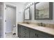 Bathroom featuring double sinks with granite countertops, gray vanity, and tiled floors at 6530 Duck Pond Dr, Fishers, IN 46038