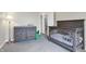 Bedroom featuring a wooden crib, changing table, and neutral carpet at 6530 Duck Pond Dr, Fishers, IN 46038
