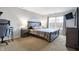 Bedroom with large window, plush carpet, TV, and bedside table at 6530 Duck Pond Dr, Fishers, IN 46038