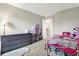 Cozy bedroom featuring a comfortable bed, dollhouse, and natural light at 6530 Duck Pond Dr, Fishers, IN 46038