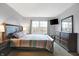 Bedroom with plush carpet, large window, TV, and comfortable furnishings at 6530 Duck Pond Dr, Fishers, IN 46038
