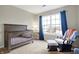 Bedroom features a crib, rocking chair, plush carpet, and large window at 6530 Duck Pond Dr, Fishers, IN 46038