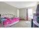 Bright bedroom with a comfortable bed, plush rug, and sunny window at 6530 Duck Pond Dr, Fishers, IN 46038