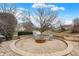 Backyard fire pit area with comfortable seating and a serene water view at 6530 Duck Pond Dr, Fishers, IN 46038