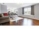 Bright living room featuring hardwood floors, neutral tones, and a large window at 6530 Duck Pond Dr, Fishers, IN 46038