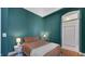Charming bedroom with teal walls and a comfortable double bed at 714 Buchanan St # 5, Indianapolis, IN 46203