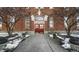 Brick building exterior with benches and snow-covered landscaping at 714 Buchanan St # 5, Indianapolis, IN 46203