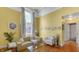 Living room with hardwood floors, yellow walls, and comfy seating at 714 Buchanan St # 5, Indianapolis, IN 46203
