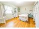 Light and airy bedroom with hardwood floors and white bed frame at 8139 Hi Vu Dr, Indianapolis, IN 46227