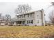 Side view of a two-story house with gray siding, brick accents, and a landscaped lawn at 8139 Hi Vu Dr, Indianapolis, IN 46227