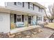 Inviting front porch with a swing and yellow chairs at 8139 Hi Vu Dr, Indianapolis, IN 46227