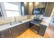 Modern kitchen with dark cabinets, granite counters, and stainless steel appliances at 8139 Hi Vu Dr, Indianapolis, IN 46227