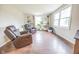 Living room with hardwood floors, built in shelves, and comfy armchairs at 8139 Hi Vu Dr, Indianapolis, IN 46227