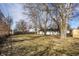 Spacious backyard features a large lawn, mature trees and privacy fence at 8815 Frontenac Rd, Indianapolis, IN 46226
