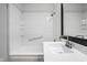 A bathroom featuring a white bathtub with tiled walls and a single vanity with a large mirror at 8815 Frontenac Rd, Indianapolis, IN 46226