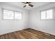 A bedroom with a ceiling fan and natural light from the two windows at 8815 Frontenac Rd, Indianapolis, IN 46226
