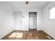 Bright bedroom features an open closet and hardwood floors, well-lit from window at 8815 Frontenac Rd, Indianapolis, IN 46226
