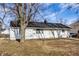 The home features a white exterior, black roof, and a well-maintained lawn at 8815 Frontenac Rd, Indianapolis, IN 46226