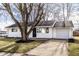 Charming single-story home with white siding, black door, and an attached one car garage at 8815 Frontenac Rd, Indianapolis, IN 46226