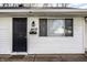 Close-up of a white home's front door and address number; 8815 with a black door and light at 8815 Frontenac Rd, Indianapolis, IN 46226