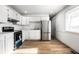 Well-lit kitchen with white cabinets and stainless steel appliances ready for cooking and entertaining at 8815 Frontenac Rd, Indianapolis, IN 46226