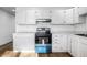 Charming kitchen with white cabinetry, modern appliances and expansive countertops at 8815 Frontenac Rd, Indianapolis, IN 46226