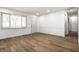 Open concept living room with new vinyl floors, fresh paint, and a modern window at 8815 Frontenac Rd, Indianapolis, IN 46226