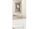 Abstract art decorates the wall above a toilet with chrome flush handle at 9113 Rockville Pl, McCordsville, IN 46055