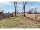 Large backyard with wooden fence and mature trees at 1058 N Holmes Ave, Indianapolis, IN 46222