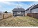 Backyard view of detached garage and fenced yard at 1058 N Holmes Ave, Indianapolis, IN 46222