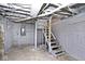 Unfinished basement with exposed utilities and wooden stairs at 1058 N Holmes Ave, Indianapolis, IN 46222