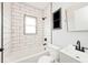 Modern bathroom with white subway tile and black fixtures at 1058 N Holmes Ave, Indianapolis, IN 46222