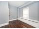 Empty bedroom with hardwood floors and window seat at 1058 N Holmes Ave, Indianapolis, IN 46222