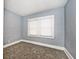 Spacious bedroom with gray walls and gray carpeting at 1058 N Holmes Ave, Indianapolis, IN 46222