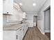 Modern white kitchen with granite countertops and stainless steel sink at 1058 N Holmes Ave, Indianapolis, IN 46222