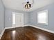 Empty living room with hardwood floors and door at 1058 N Holmes Ave, Indianapolis, IN 46222