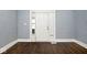 Empty living room with hardwood floors and door at 1058 N Holmes Ave, Indianapolis, IN 46222