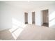 Bright bedroom with neutral carpet, two closets, and a view into the bathroom with glass-enclosed shower at 1132 Fleming Dr, Greenfield, IN 46140