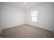 Well-lit bedroom features neutral carpeting and a large window at 1132 Fleming Dr, Greenfield, IN 46140
