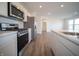 Modern kitchen featuring stainless steel appliances, quartz countertops, and wood-look floors at 1132 Fleming Dr, Greenfield, IN 46140