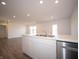 Well-lit kitchen with stainless steel appliances, quartz countertops, and recessed lights at 1132 Fleming Dr, Greenfield, IN 46140