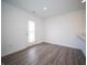 Bright living room featuring wood-look floors, a glass door, and fresh, neutral paint at 1132 Fleming Dr, Greenfield, IN 46140
