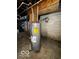 Unfinished basement with water heater and exposed pipes at 1154 N Belleview Pl, Indianapolis, IN 46222