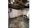 Unfinished basement with exposed utilities and concrete floor at 1154 N Belleview Pl, Indianapolis, IN 46222