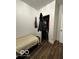 Bedroom with a twin bed, closet, and dark flooring at 1154 N Belleview Pl, Indianapolis, IN 46222