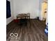 Dining area with oval table and two chairs, dark floors at 1154 N Belleview Pl, Indianapolis, IN 46222